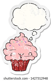 cute cartoon frosted cupcake with thought bubble as a distressed worn sticker