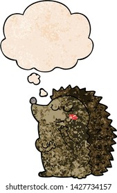 cute cartoon hedgehog with thought bubble in grunge texture style