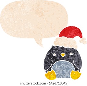 cute cartoon penguin wearing christmas hat with speech bubble in grunge distressed retro textured style