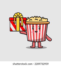 Cute cartoon Popcorn character holding gift box in vector icon illustration