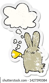 cute cartoon rabbit drinking coffee with thought bubble as a distressed worn sticker