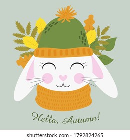 Cute cartoon rabbit in a hat and scarf on a background of autumn leaves. Hello, Autumn! Flat vector illustration isolated on blue background.