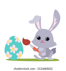 Cute cartoon rabbit painting an Easter egg