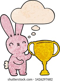 cute cartoon rabbit with sports trophy cup with thought bubble in grunge texture style