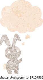 cute cartoon rabbit with thought bubble in grunge distressed retro textured style