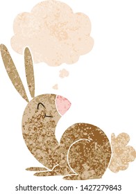 cute cartoon rabbit with thought bubble in grunge distressed retro textured style