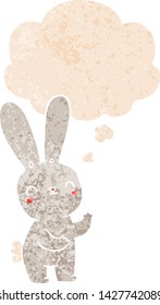 lindo conejo de dibujos animados con burbuja de pensamiento en un estilo retro angustiado estilo texturizado