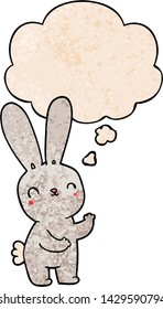 cute cartoon rabbit with thought bubble in grunge texture style
