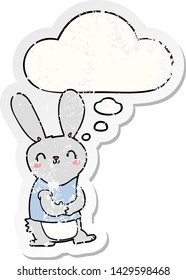 cute cartoon rabbit with thought bubble as a distressed worn sticker
