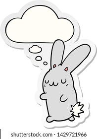 süßes Cartoon-Kaninchen mit Denkblase als Druckaufkleber