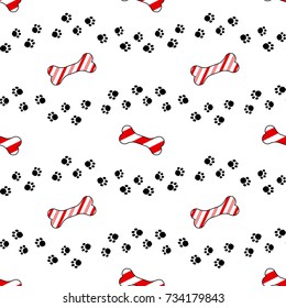 Cute cartoon seamless pattern design. Dog paw print trails and candy cane in shape of bone biscuit treat.