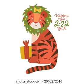 Cute cartoon striped red tiger with gift box and Christmas wreath on his head . Funny baby tiger - symbol of 2022 year. Happy New Year greeting card. Flat vector illustration.