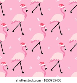 Cute cartoon style pink tropical flamingos in Santa hats, vector seamless pattern background for Christmas design.