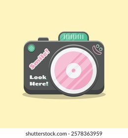 A cute, cartoon and stylized camera vector illustration. Light teal text is layered on the camera body saying "Smile!" and "Look Here!". Also a small, simple smiley face graphic.