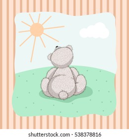 Cute cartoon Teddy Bear sitting in a meadow and looks at the sun.