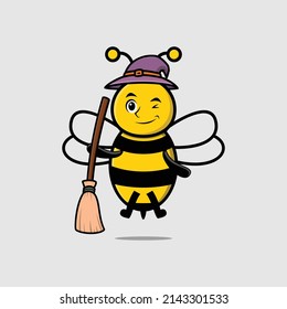 Cute cartoon witch shaped bee character with hat and broomstick