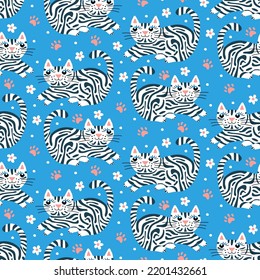 Cute cat print for baby fabric. Pets pattern for infant textiles, girls dresses, newborn clothes. Seamless wallpaper on blue background with animals, flowers, paw prints. Cartoon striped tabby kitty. 