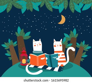 Cute cat reads a book under the tree. Funny animal relaxing in park