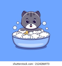 un gato lindo bañándose con juguete de pato y burbujas