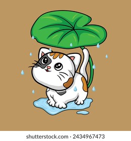 cute cat taking shelter under a leaf
