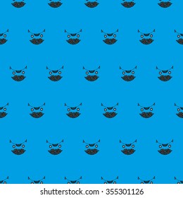 Cute cat's head seamless pattern on a blue background. Vector illustration