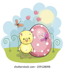 Cute chicken with egg on the meadow