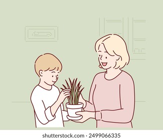 Cute child boy helping her mother to care for plants. Hand drawn style vector design illustrations.