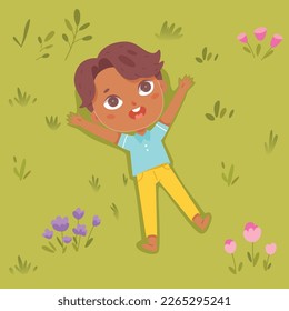 Cute child lying on green grass of summer park with lawn or playground, top view vector illustration. Cartoon boy on meadow, funny child relaxing among plants and flowers during picnic background.