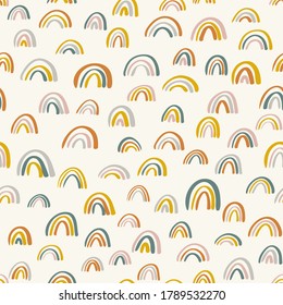 Cute childish rainbows pattern. Nursery pattern for children. Scandinavian wallpaper for kids. Hand drawn rainbow doodle vector seamless pattern background in bright colors. Girls room decoration.