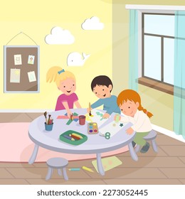 Cute children drawing together and make crafts in kindergarten