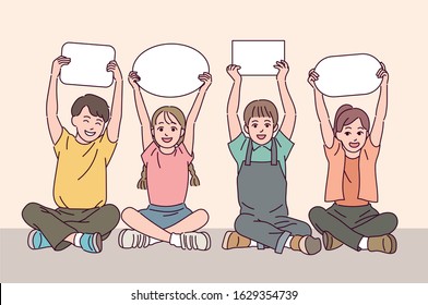 Cute children are sitting on the floor and holding white cardboard. hand drawn style vector design illustrations. 