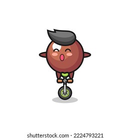The cute chocolate ball character is riding a circus bike , cute style design for t shirt, sticker, logo element