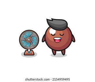 cute chocolate ball is standing in front of the fan , cute design