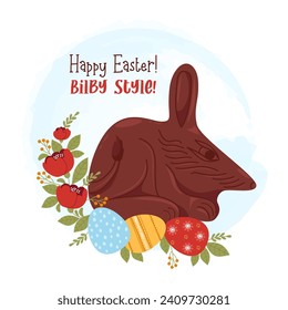 Cute chocolate bilby with Easter eggs and flowers and greeting. Vector illustration. Festive paschal colorful card with Australian animal symbol.