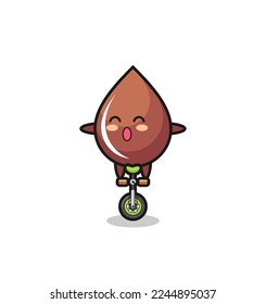 The cute chocolate drop character is riding a circus bike , cute style design for t shirt, sticker, logo element