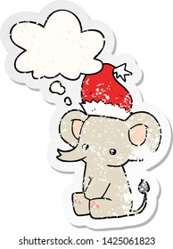 cute christmas elephant with thought bubble as a distressed worn sticker