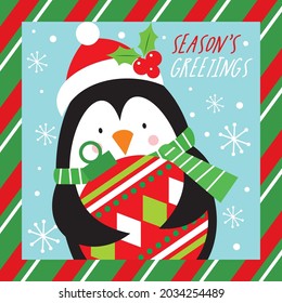 Cute christmas penguin holding bauble for christmas card, gift bag or box design