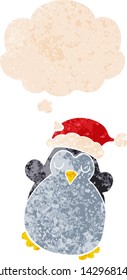 cute christmas penguin with thought bubble in grunge distressed retro textured style