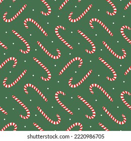 Cute Christmas vector seamless pattern background with candy cane and dots.