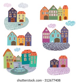 Cute colorful fairy houses with cats and pavement