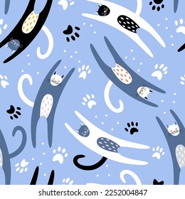 Cute colorful hand drawn cats with paws shape on blue background. Seamless vector cute pattern with pet animal. Print for nursery