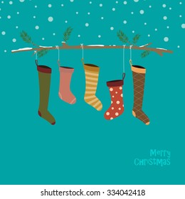 Cute colorful socks hanging on strings on a branch covered with snow. Christmas retro card template in flat design in vector.
