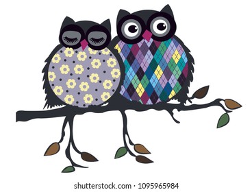 Cute couple of owls sit on the branch