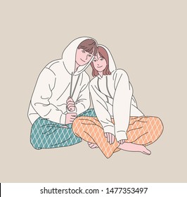 Cute couple sit in the same clothes. hand drawn style vector design illustrations. 