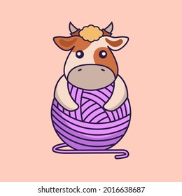 Cute cow playing with wool yarn.