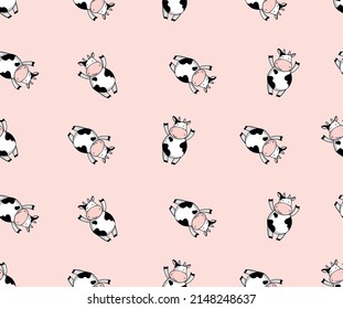 Cute cow seamless vector pattern on pink background