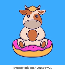 Cute cow is sitting on donuts.