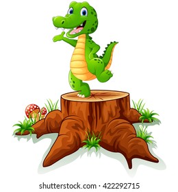 Cute crocodile posing on tree stump