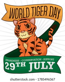 Cute cub standing this 29th July to celebrate World Tiger Day, between commemorative ribbons with some precepts promoting awareness, conservation and support.