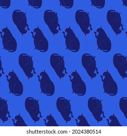 Cute dark navy black cat licking his paw on the blue background. Seamless vector pattern hand drawn. Wallpaper, wrapping paper, cards and children book adorable illustration.